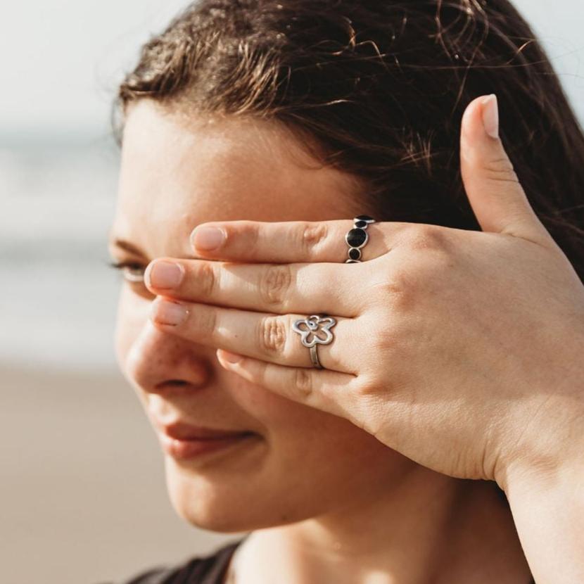 Flower power adjustable ring and bubbles adjustable ring together. Photo taken of a pre-teen girl on the beach in New Zealand. 