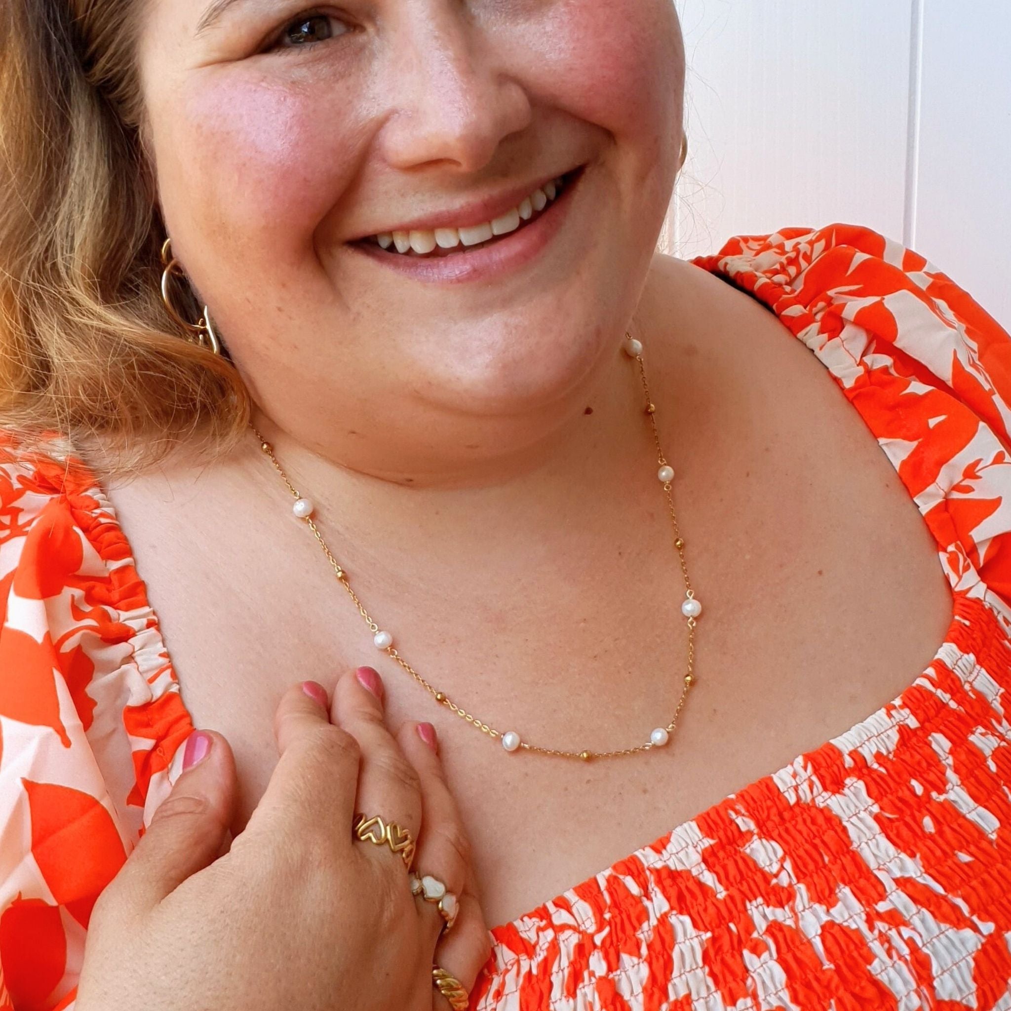 Plus-size woman wearing the 60cm Ocean Whispers Freshwater Pearl Necklace, featuring 18K gold-plated chain and natural freshwater pearls, adding elegance to any look.